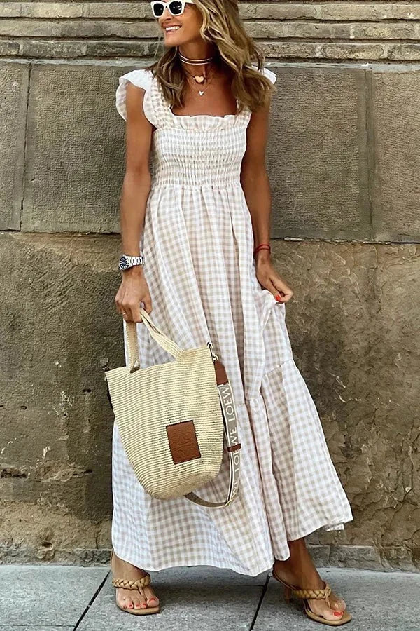 White breezy maxi dress with ruffled cap sleeves. Flowy and elegant, perfect for a day out or special occasion.