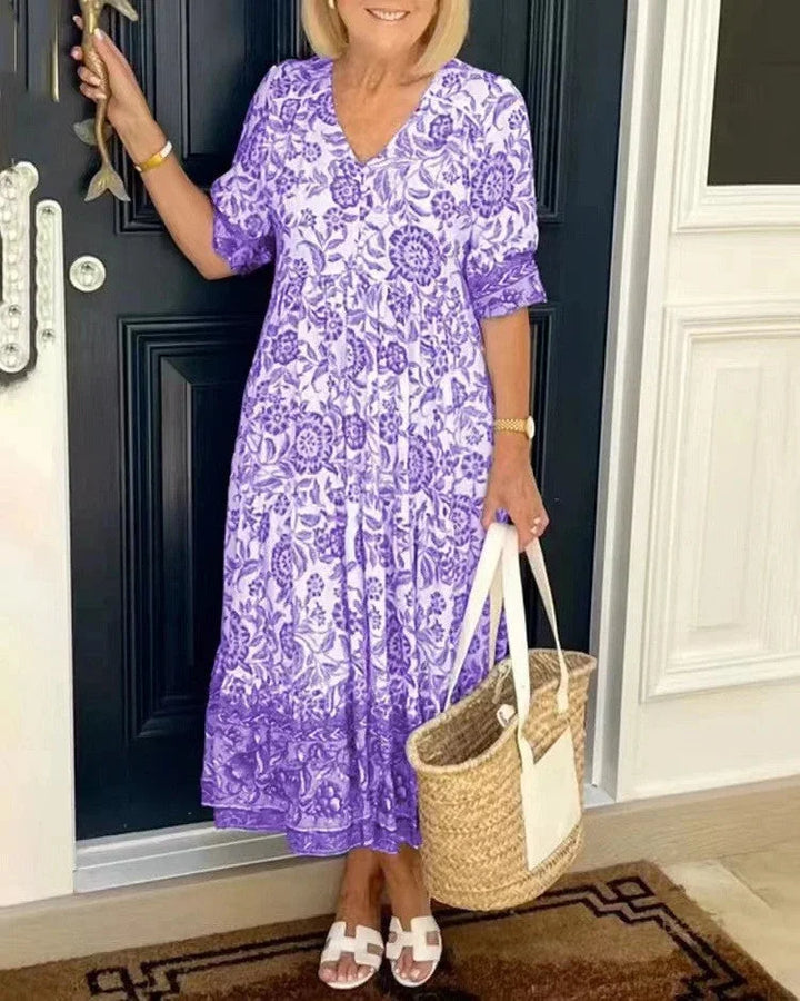 Purple V-neck dress with tapered sleeves by Romi. Made of soft, flowy fabric, perfect for stylish and comfortable everyday…