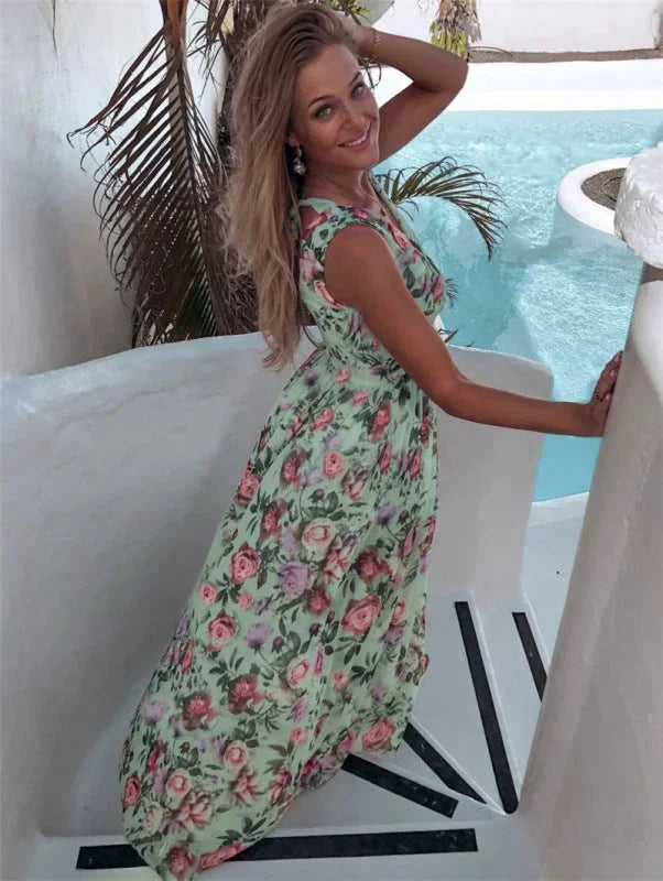 Sleeveless floral maxi dress with split-front design, ideal for sunny days.