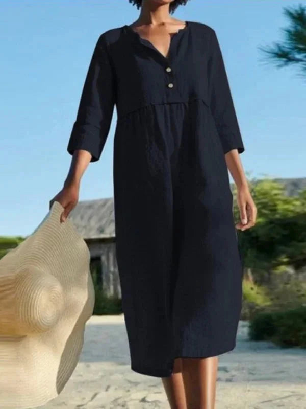 "Sayuri V-neck midi dress in a versatile design made for comfort and style with convenient pockets."