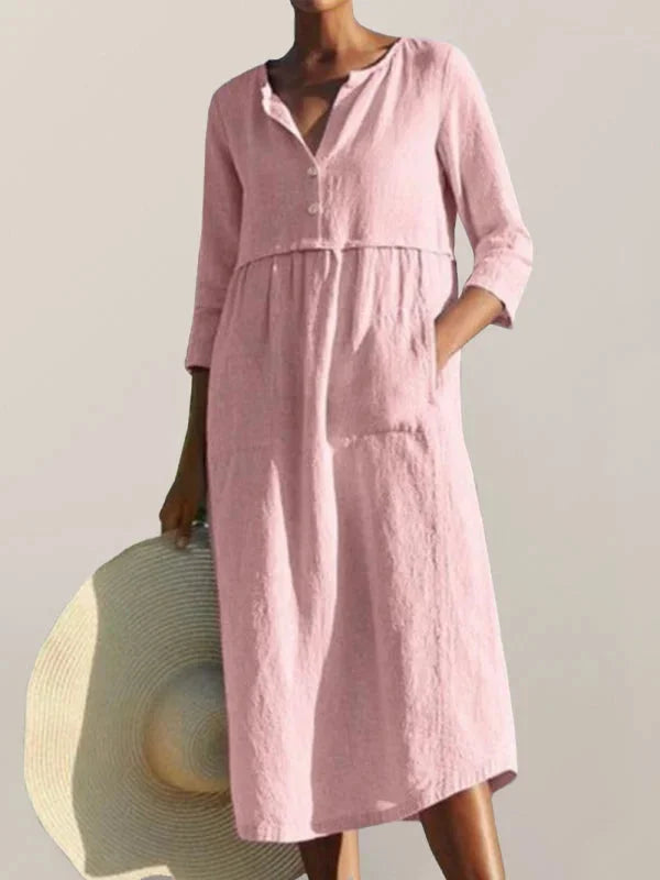 "Versatile Pink V-neck midi dress with pockets in soft fabric, perfect for everyday wear or special occasions."