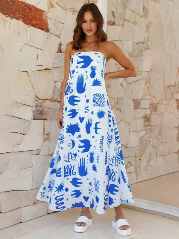 "Deep blue strapless maxi dress with colorful abstract prints flowing in tiers, perfect for a summer day out."