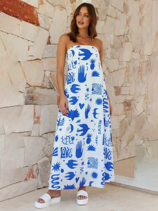 Blue flowing strapless maxi dress with vibrant prints in a soft and lightweight fabric, perfect for a casual summer look.