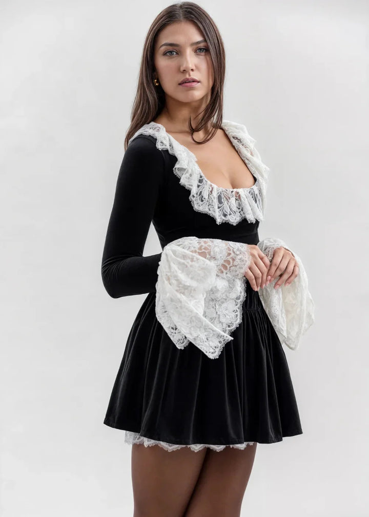 Black mini dress featuring voluminous lace sleeves, perfect for a sophisticated and elegant look.