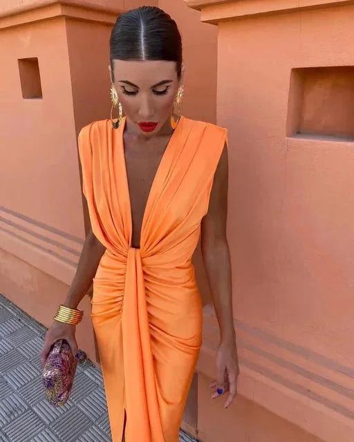 Orange V-neck jumpsuit with pleats, made for comfort with a draped design. Perfect for a chic and stylish look.