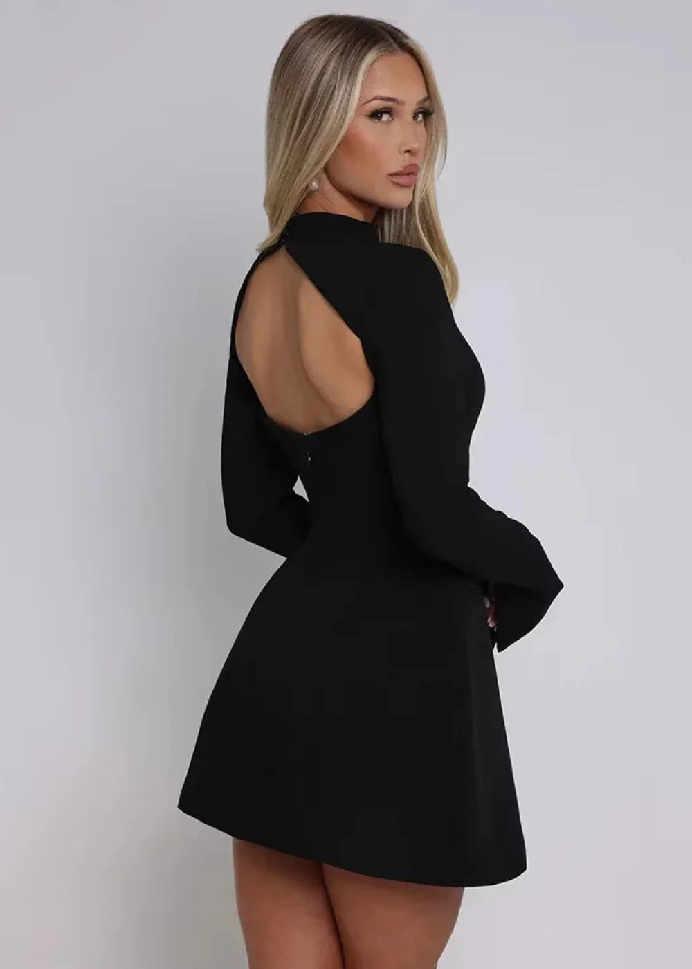 Navy blue flared dress with long sleeves and open back, perfect for day or night events.