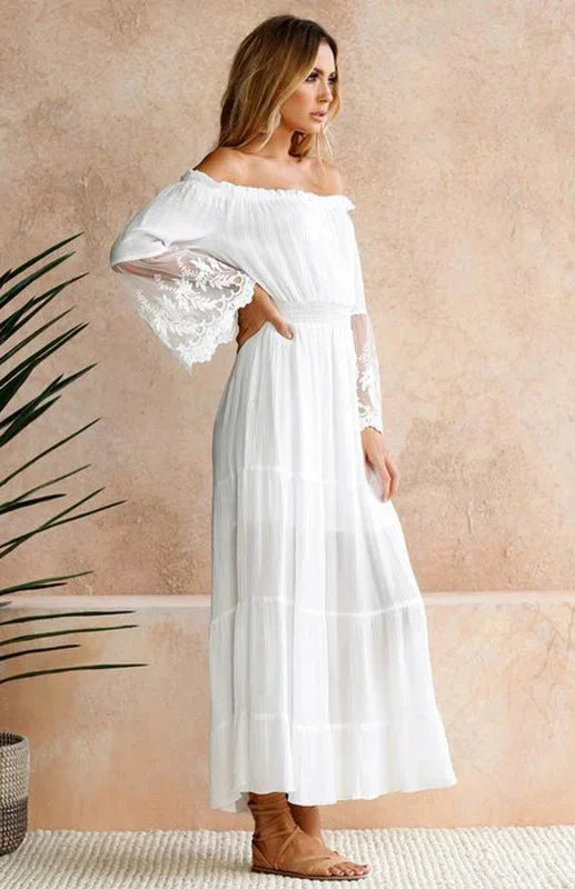 White off-shoulder dress with lace sleeves, tiered design, perfect for a summer day out.