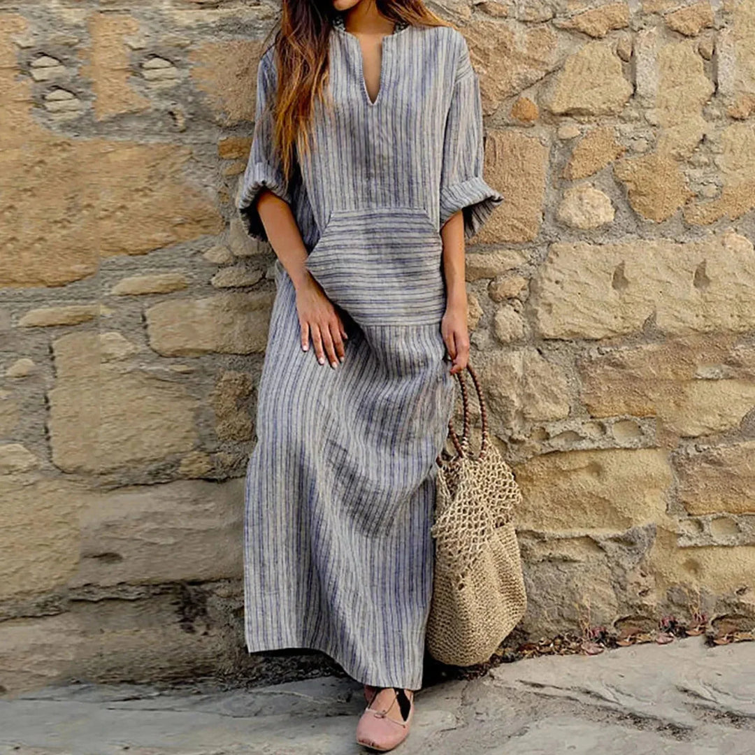 "Sierra maxi dress in striped pattern with V-neck and convenient pockets, perfect for casual chic style."