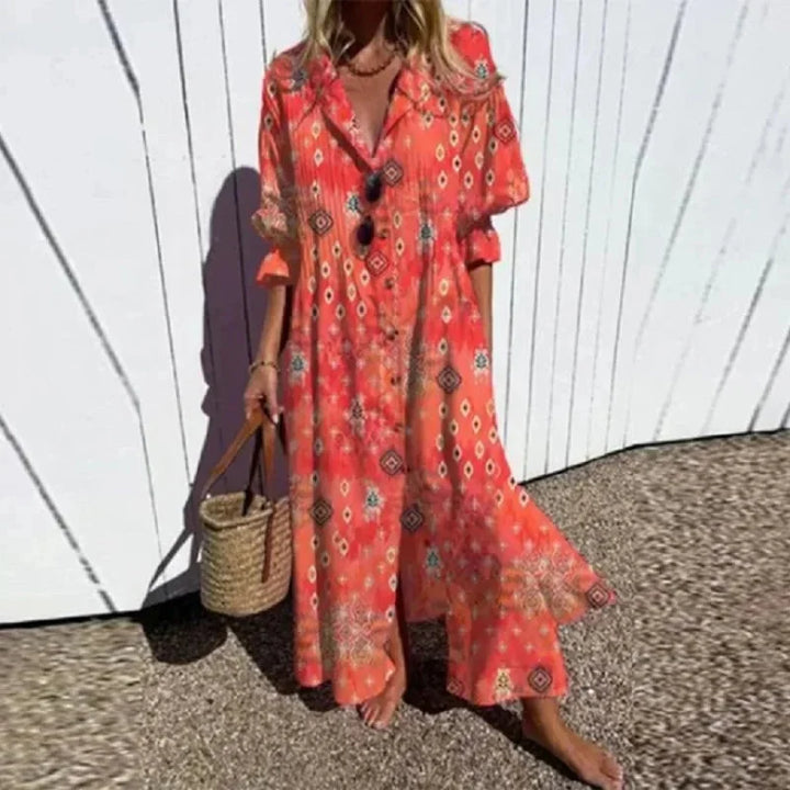 "Red V-neck maxi dress with floral pattern, long sleeves, made from lightweight fabric."