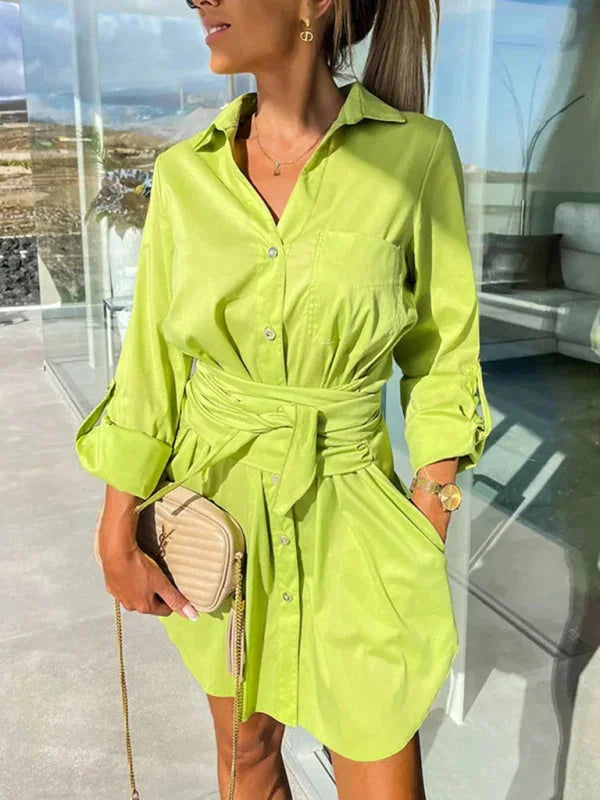 Green yellow shirt dress with belt, adjustable sleeves, and versatile design. Made of comfortable and durable fabric.