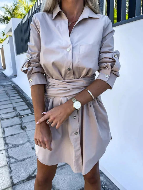 Khaki shirt dress with adjustable sleeves and belt. Versatile and functional design for everyday wear.