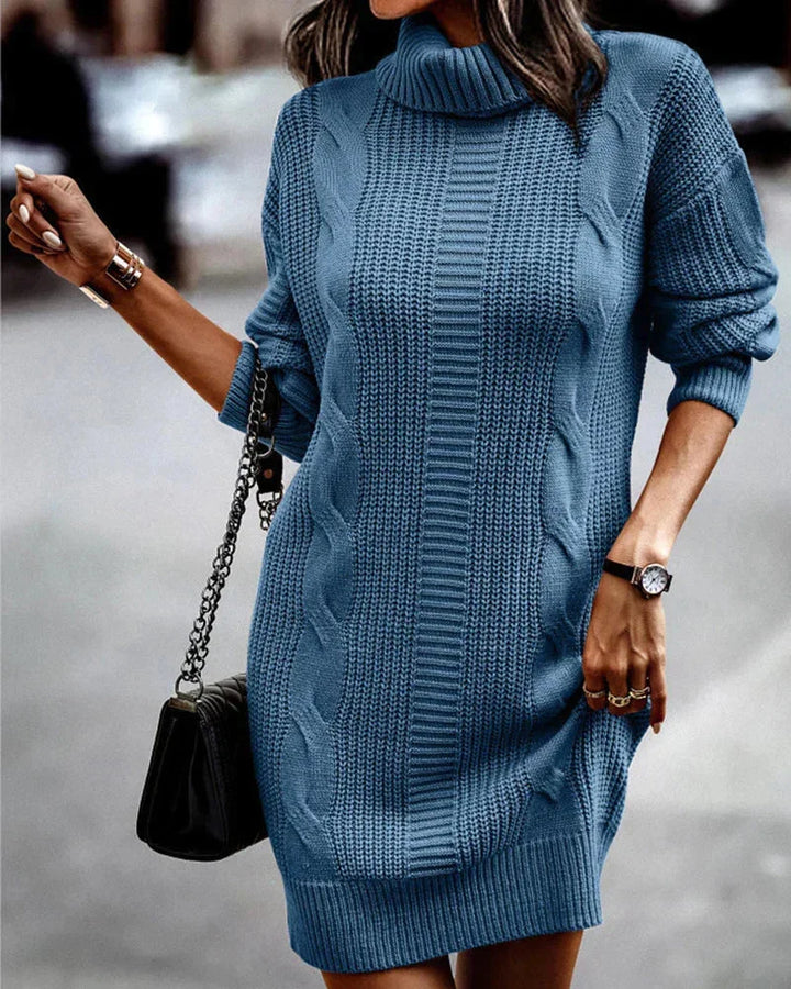 Blue knit sweater dress with turtleneck, featuring elegant design and cozy fabric perfect for cooler seasons.