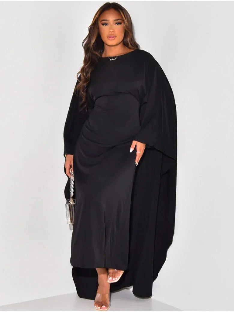 "Black maxi dress with draped sleeves, sleek silhouette, and soft fabric for a sophisticated look."