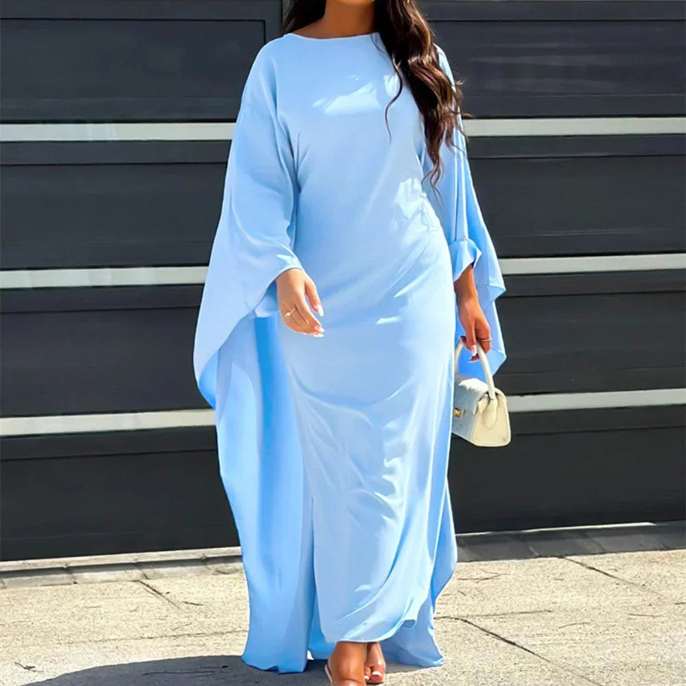 Light blue, elegant maxi dress with draped sleeves. Soft and flowy fabric with a simple yet sophisticated design.