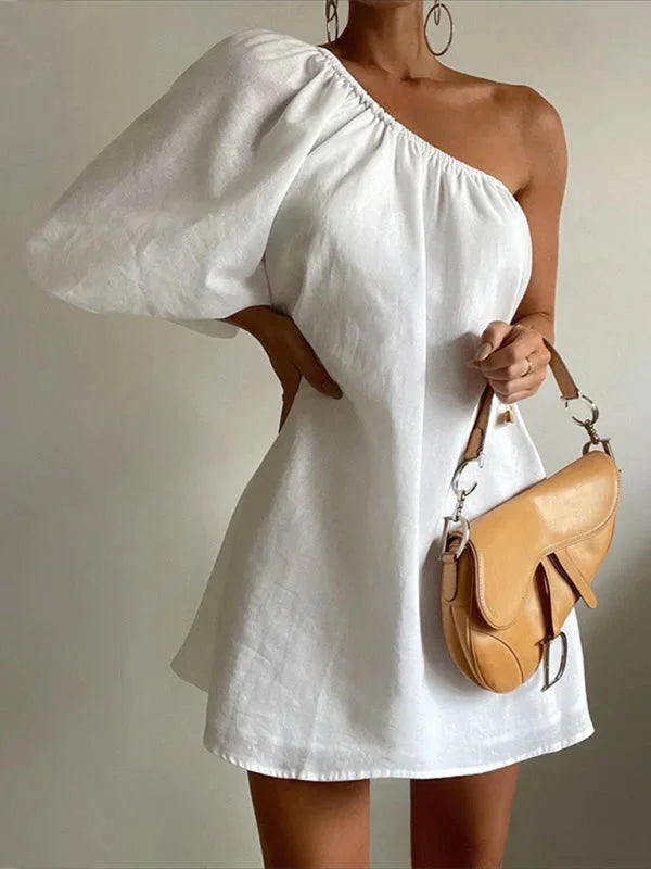 Off-shoulder puffed sleeve mini dress in soft cotton blend, perfect for summer days with a flattering fit.