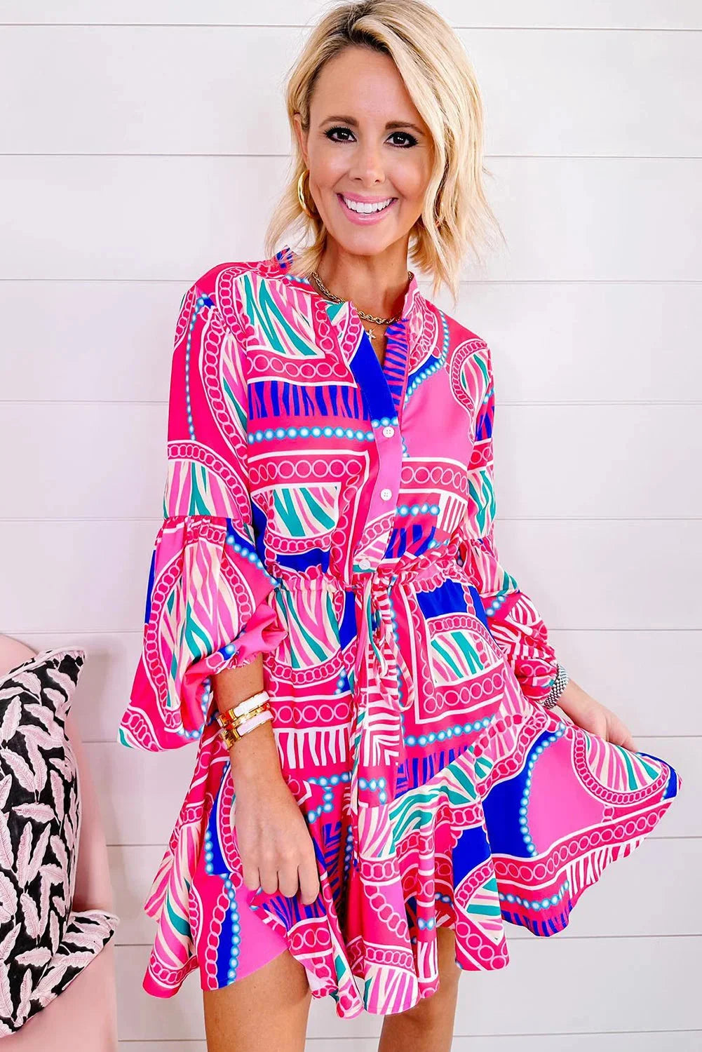 Alt text: "Vibrant pink tribal print mini dress showcasing intricate pattern on light and airy fabric for a stylish and…