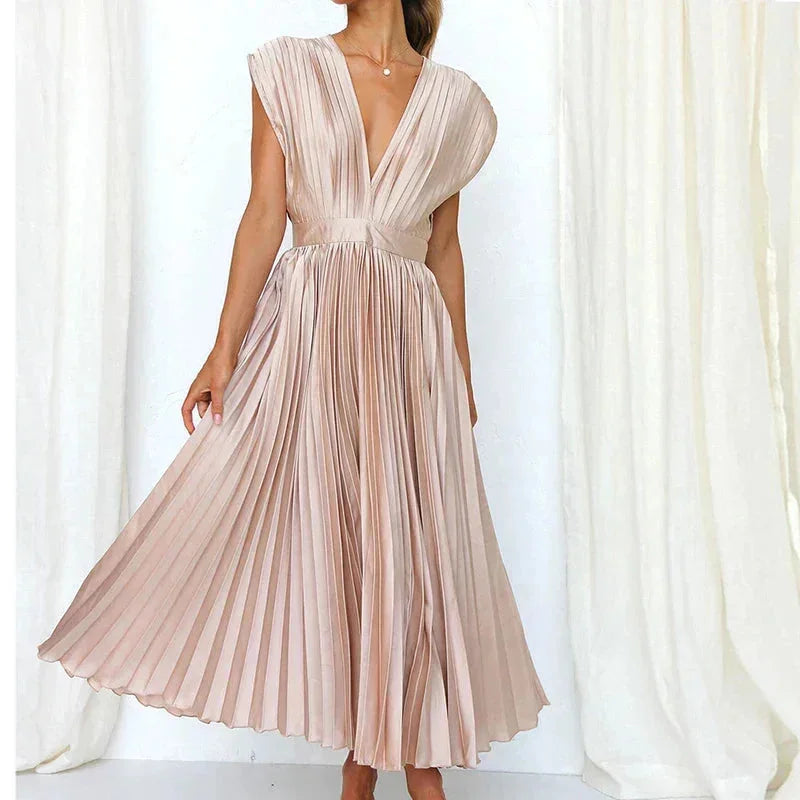 "Rose pleated dress featuring a deep V-neckline, perfect for elegance and style. Fabric: polyester blend."