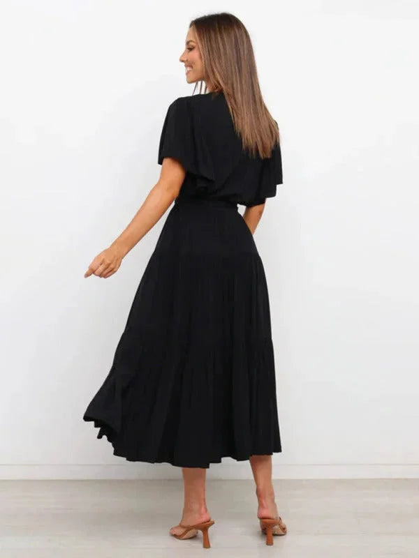 "Valentina tiered midi dress in navy blue with a belted waist, perfect for a casual yet stylish look."