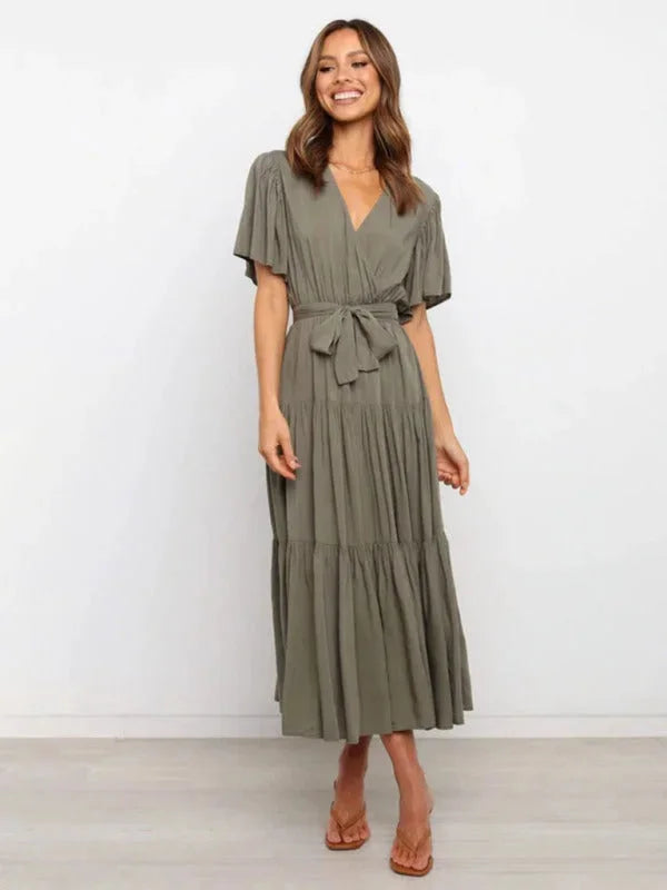 Olive green tiered midi dress with belt, featuring a flowy silhouette and made of soft, lightweight fabric for effortless…