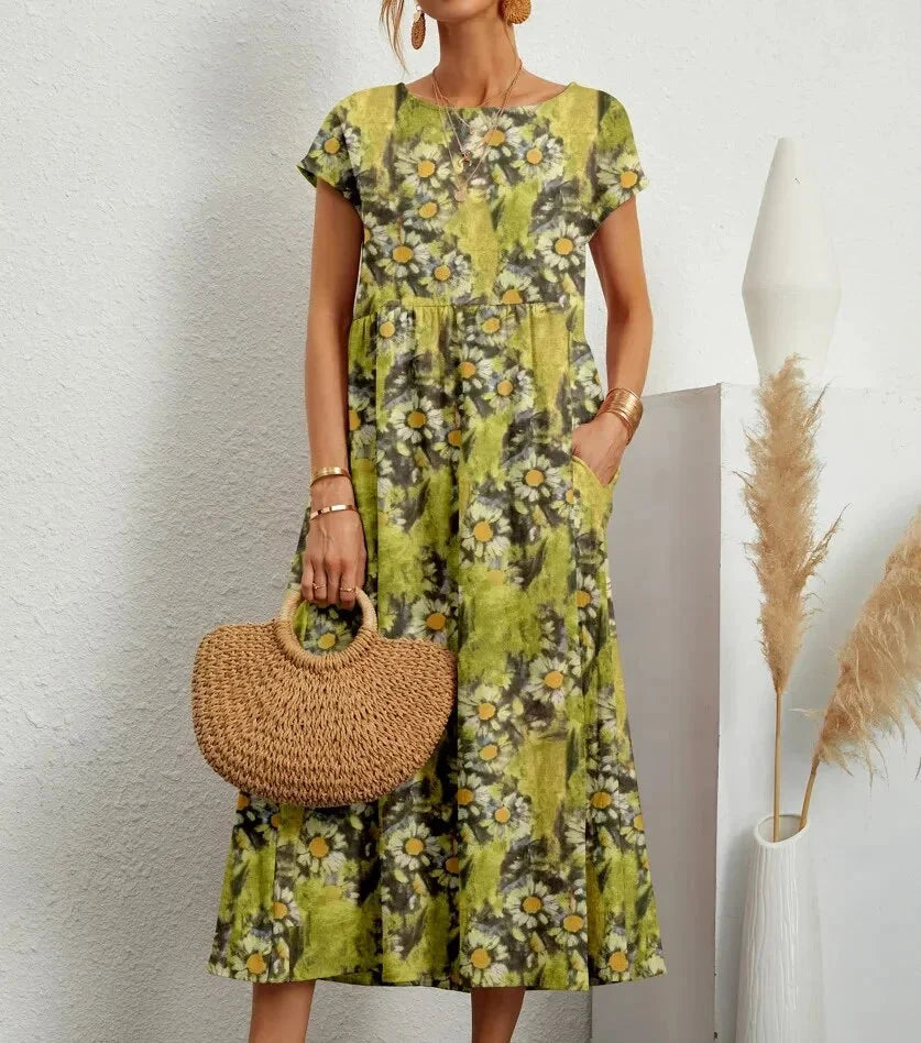 Light green cotton midi dress with intricate floral print design in Vivia collection. Perfect for a chic and effortless…