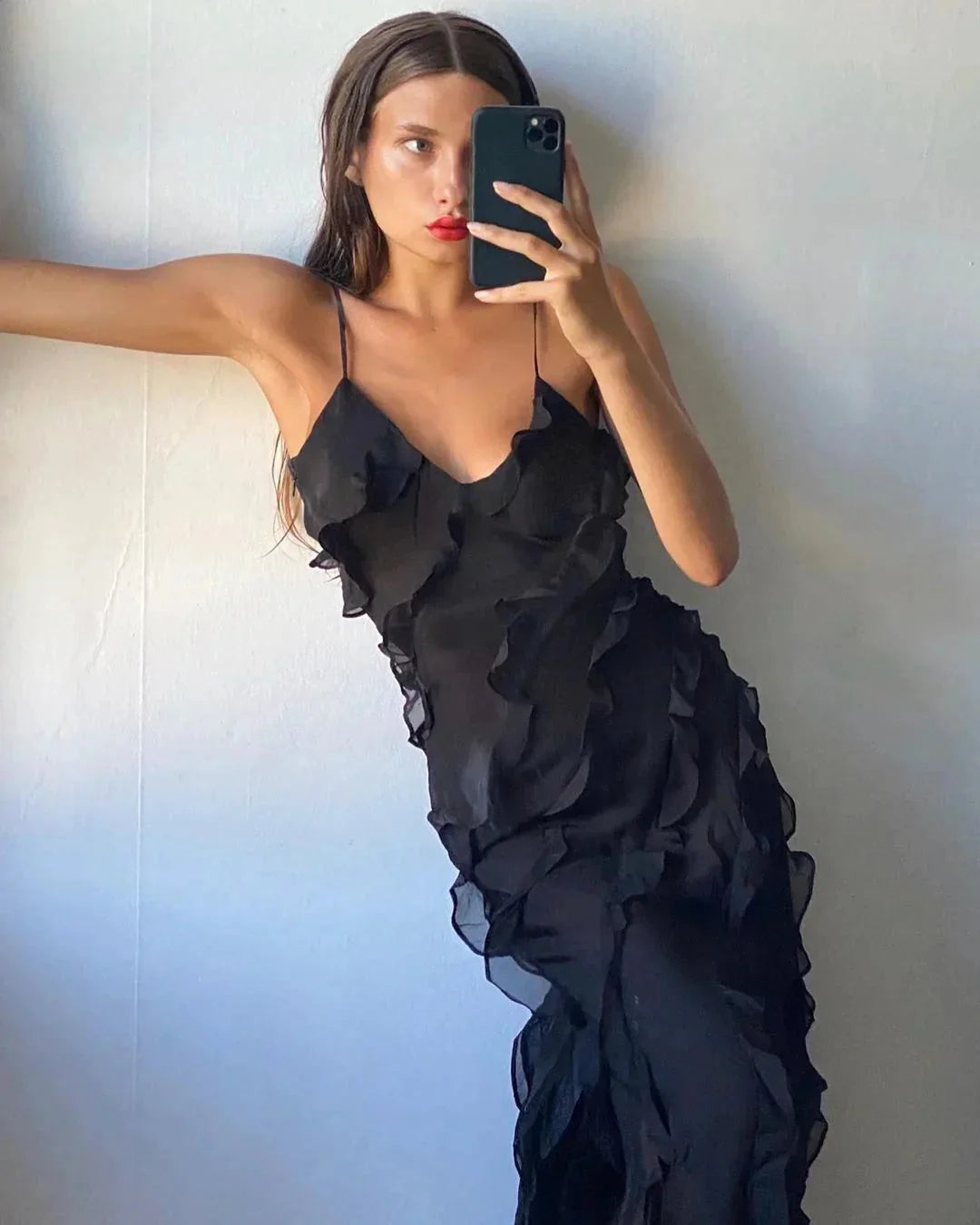 Black ruffled maxi dress with V-neck and flowy silhouette for evening events.