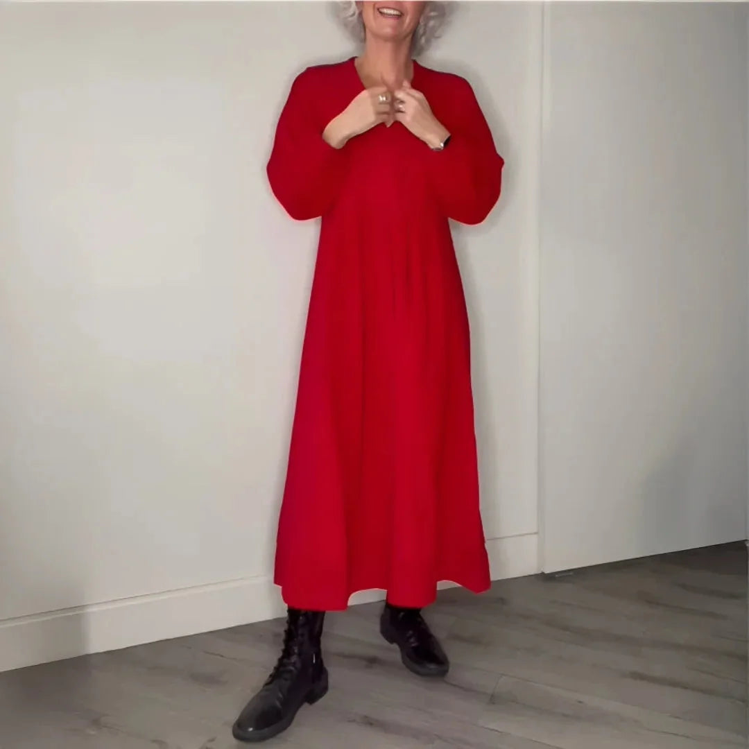 Red maxi dress with long sleeves, perfect for cooler days. Versatile and comfy outfit made from soft, durable fabric.