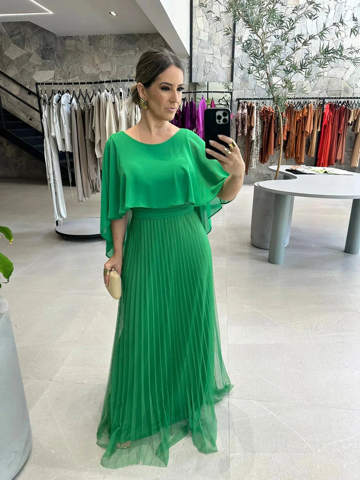 Green floor-length dress with flowing sleeves made of soft chiffon fabric. Elegant silhouette perfect for special occasions.