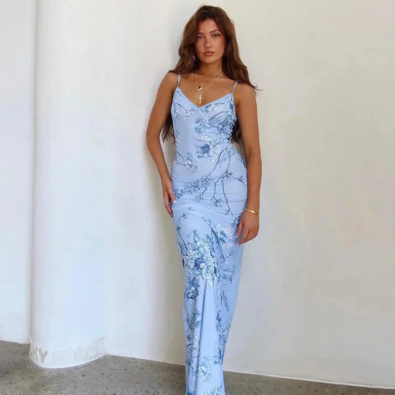 Blue floral maxi dress with spaghetti straps. Made from lightweight fabric with a flowy design. Perfect for a casual summer…