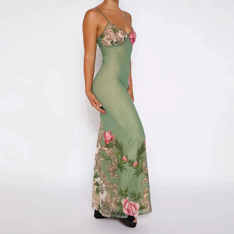 Green floral maxi dress with spaghetti straps. Flowy and vibrant design perfect for summer.