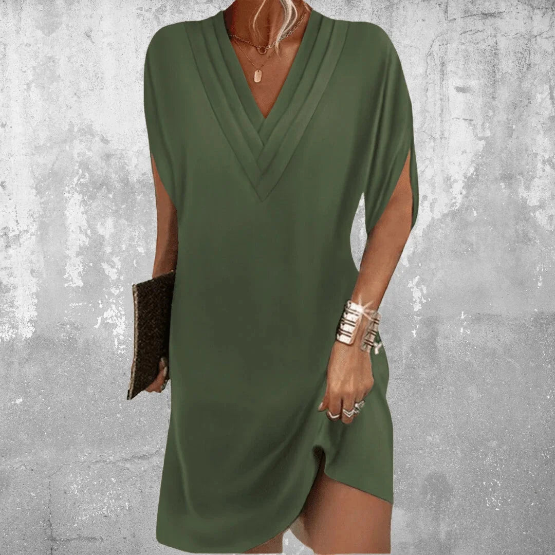 Military green Zoey dress with V-neck and slit sleeves, made from soft, flowy fabric. Perfect for a chic and relaxed look.