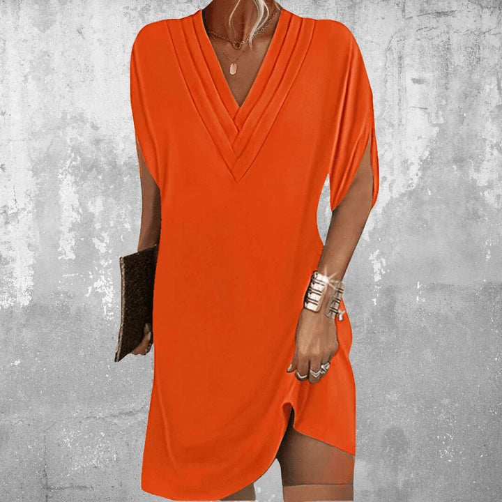 "Orange V-neck mini dress with slit sleeves, perfect for an elegant evening out, made from lightweight flowing fabric."