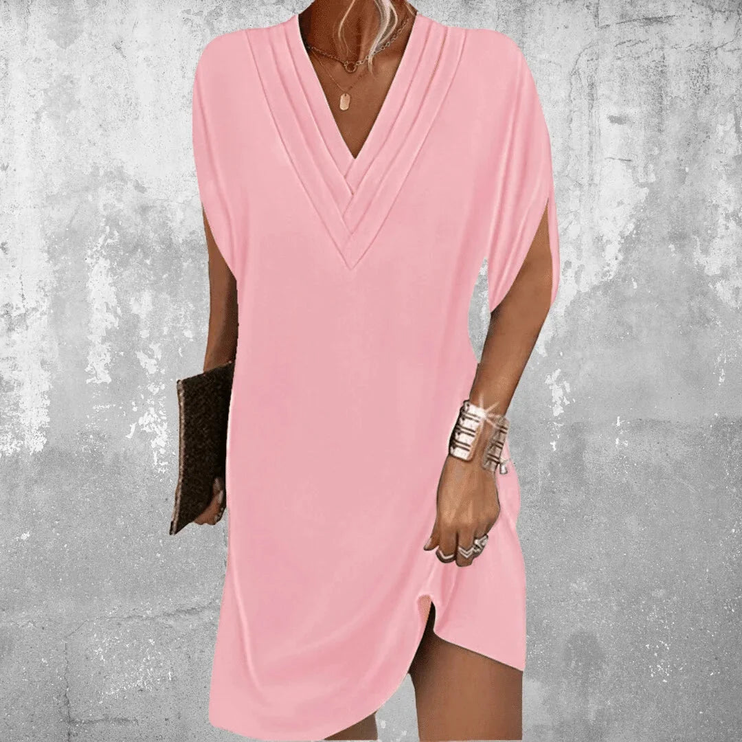 Pink V-neck mini dress with slit sleeves. Made from soft, breathable fabric. Stylish and trendy design for a fashionable…